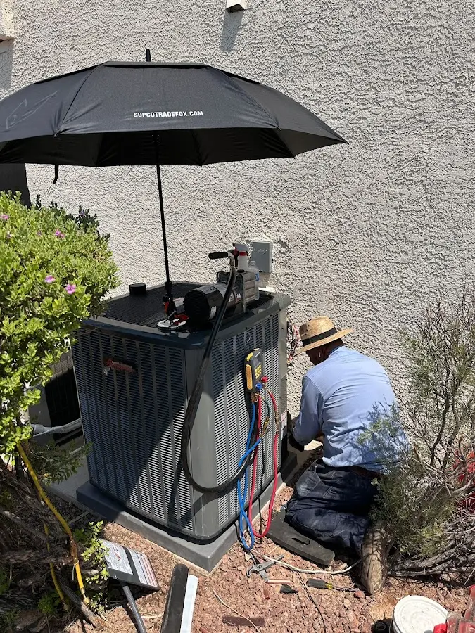 HVAC technician performing outdoor AC maintenance in North Bend